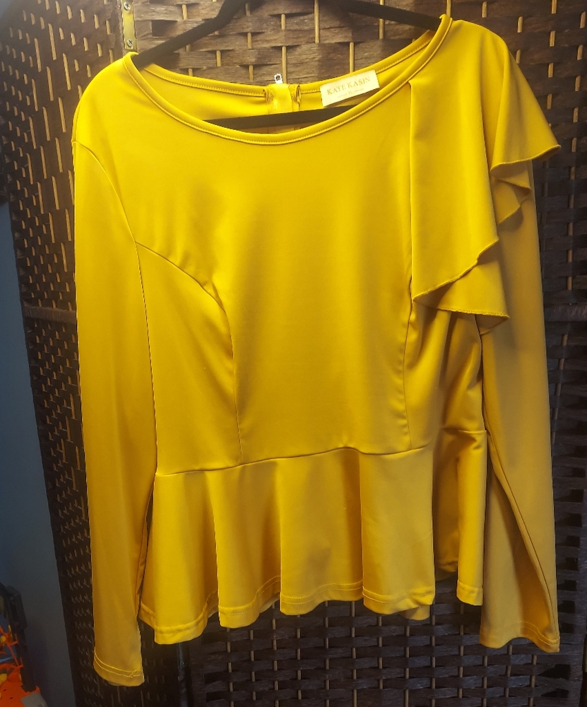 Yellow goldtone peplum long sleeve top.
